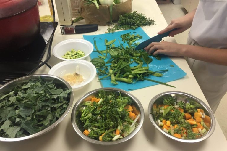 Magnolia Montessori Academy students prepare salad with vegetables from the school garden