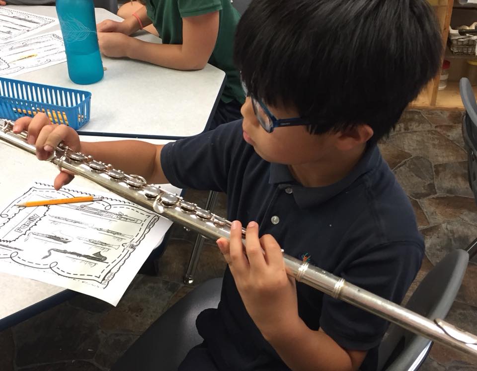 Student holds a flute